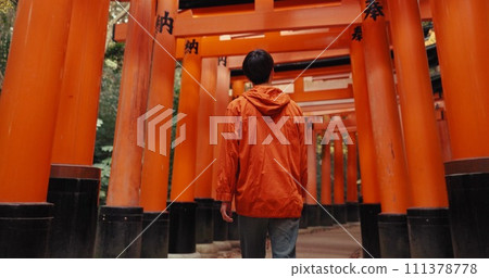 Man, religion and walk by shinto torii gate, back and culture for thinking, ideas and nature in forest. Person, statue and memory on spiritual journey, Fushimi Inari shrine or architecture in Kyoto Man, religion and walk by shinto torii gate, back and culture for thinking, ideas and nature in forest. Person, statue and memory on spiritual journey, Fushimi Inari shrine or architecture in Kyoto 111378778