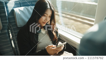 Japan woman, travel and train on smartphone, social media and public transportation on metro bullet. Person, cellphone and online on fast vehicle for weekend trip and commute in tokyo for adventure 111378782