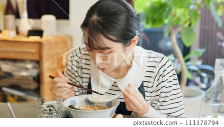Restaurant, food and Japanese woman with noodles for eating meal, lunch and dinner in cafe. Ramen, cafeteria supper and person with chopsticks for traditional cuisine for health, wellness and hunger Restaurant, food and Japanese woman with noodles for eating meal, lunch and dinner in cafe. Ramen, cafeteria supper and person with chopsticks for traditional cuisine for health, wellness and hunger 111378794