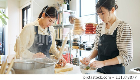 Cooking class, restaurant and women with Japanese food in a kitchen with chef and learning professional skill. Student, education and Asian cuisine course with people together working on skills 111378877