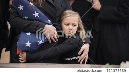 USA veteran funeral, girl and sad family with hug, care and flag for mourning, depression and comfort with mom. Kid, people and service with coffin, burial or memorial with war hero in Philadelphia 111378889