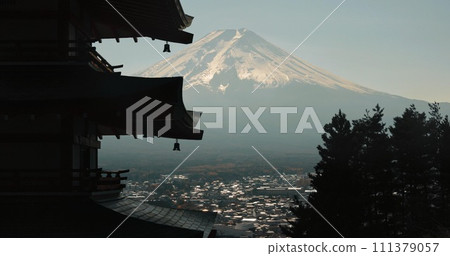 Chureito Pagoda, Mount Fuji and view of city in morning with temple, trees and blue sky on travel. Japanese architecture, culture and spiritual history with mountain, snow and calm Asian landscape. 111379057