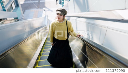 Woman, escalator and Japanese travel or journey destination booking, airport or holiday. Female person, Tokyo and passenger or boarding international flight or adventure explore, vacation or tour 111379090