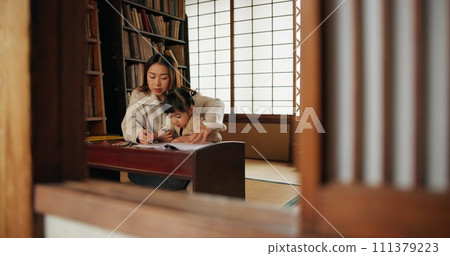 Mother, child and drawing helping or pencil for home schooling lesson, Japanese or tutor. Female person, girl daughter and book paper in Tokyo or writing teach for art studying, creative or activity 111379223