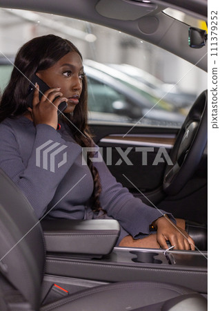 Businesswoman on the Phone in Car Businesswoman on the Phone in Car 111379252