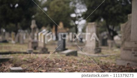 Graveyard, burial and tombstone in cemetery for death ceremony, funeral ritual and memorial service. Headstone, rip and resting place of departed for mourning, loss and remembrance of dead by church Graveyard, burial and tombstone in cemetery for death ceremony, funeral ritual and memorial service. Headstone, rip and resting place of departed for mourning, loss and remembrance of dead by church 111379273
