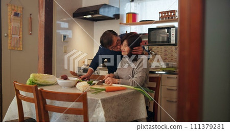 Cooking, love and Japanese couple in kitchen cutting vegetables for meal, dinner or lunch. Happy, kiss and senior man and woman bonding and preparing food for supper together with produce at home. 111379281