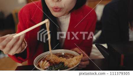 Woman, mouth and blowing ramen noodles in restaurant for dinner, diet and meal in cafeteria. Closeup, hungry lady and chopsticks for eating hot spaghetti, Japanese cuisine or lunch in fast food diner Woman, mouth and blowing ramen noodles in restaurant for dinner, diet and meal in cafeteria. Closeup, hungry lady and chopsticks for eating hot spaghetti, Japanese cuisine or lunch in fast food diner 111379305