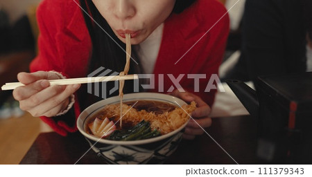 Woman, mouth and eating ramen in restaurant for dinner, meal and noodles in cafeteria. Closeup, hungry lady and chopsticks for bowl of spaghetti, Japanese cuisine and lunch break in fast food diner 111379343