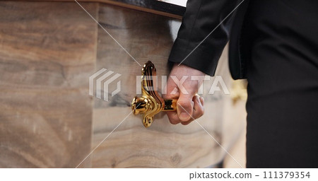 Coffin, hands and pallbearer walking at cemetery ceremony outdoor at tomb. Death, grief and person with casket at funeral, carrying to graveyard or family service of people mourning at farewell event 111379354
