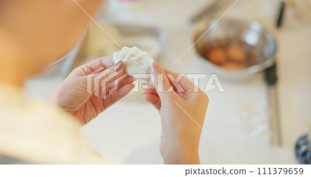Japan, hands and dumplings in kitchen for dinner, brunch and traditional meal in restaurant or cafe. Culture, gyozo and asian cuisine for nutrition, healthy diet and lunch with preparation or pastry Japan, hands and dumplings in kitchen for dinner, brunch and traditional meal in restaurant or cafe. Culture, gyozo and asian cuisine for nutrition, healthy diet and lunch with preparation or pastry 111379659