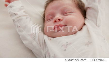Baby, sleeping stretch and nursery bed with morning, nap and dreaming of a young newborn at home. Cozy, sleepy kid and calm with health development from rest and peace in house with closeup and care Baby, sleeping stretch and nursery bed with morning, nap and dreaming of a young newborn at home. Cozy, sleepy kid and calm with health development from rest and peace in house with closeup and care 111379660