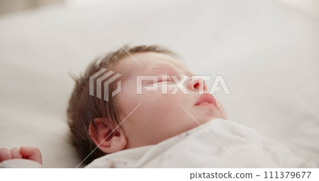 Baby, face and sleeping in the morning on nursery bed and blanket with nap and rest. Relax, calm and tired newborn with youth on bedding with kid sleeping from above in a family home and bedroom Baby, face and sleeping in the morning on nursery bed and blanket with nap and rest. Relax, calm and tired newborn with youth on bedding with kid sleeping from above in a family home and bedroom 111379677