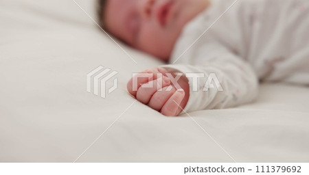 Hand, newborn and sleeping on bed in nursery with relaxing, resting and nap on blanket in morning. Baby, peaceful and dreaming in bedroom of home for child development, growth and nurture or relax Hand, newborn and sleeping on bed in nursery with relaxing, resting and nap on blanket in morning. Baby, peaceful and dreaming in bedroom of home for child development, growth and nurture or relax 111379692