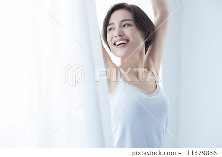 Young woman wearing a camisole relaxing 111379836