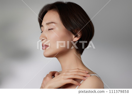 Skin care image of a young woman photographed against a background of light and shadow 111379858