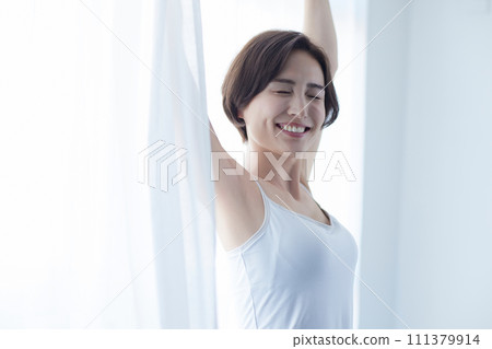 穿著吊帶背心放鬆的年輕女子 穿著吊帶背心放鬆的年輕女子 111379914
