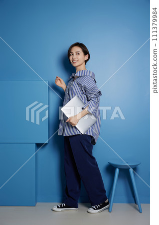 Business image of young woman on blue background 111379984