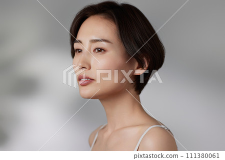 Skin care image of a young woman photographed against a background of light and shadow 111380061