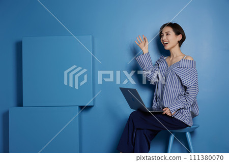 Business image of young woman on blue background Business image of young woman on blue background 111380070
