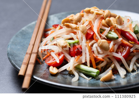 Green Papaya Salad, som tam thai on black slate background Green Papaya Salad, som tam thai on black slate background 111380925
