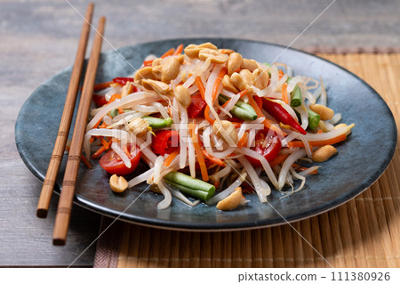 Green Papaya Salad, som tam thai on black slate background 111380926