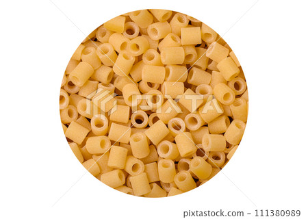 Raw ditali pasta made from durum wheat on a dark concrete background Raw ditali pasta made from durum wheat on a dark concrete background 111380989