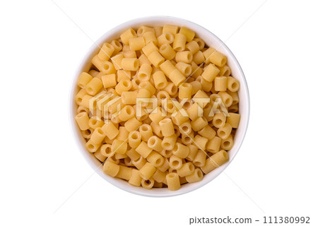 Raw ditali pasta made from durum wheat on a dark concrete background 111380992