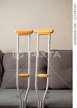 Close-up of metal crutches. Crutches for broken legs rest on the sofa 111381397