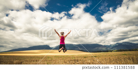 Young woman jumping in the mountains Young woman jumping in the mountains 111381588