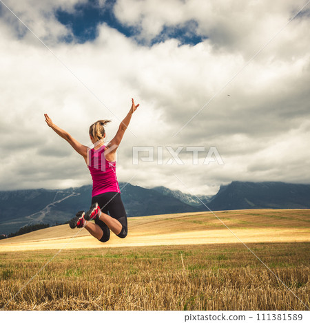 Young woman jumping in the mountains Young woman jumping in the mountains 111381589