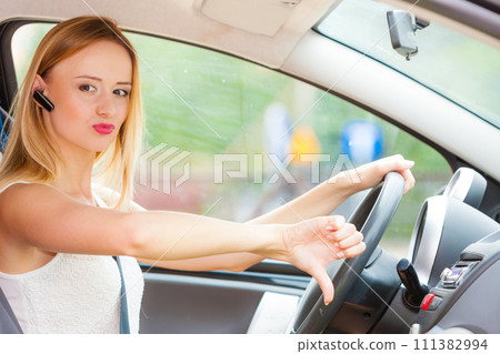 woman driving car annoyed by heavy traffic woman driving car annoyed by heavy traffic 111382994