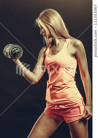 Fit woman exercising with dumbbells. Fit woman exercising with dumbbells. 111383067