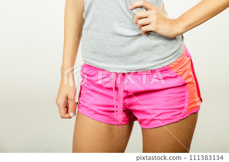 Female hips in sporty shorts 111383134