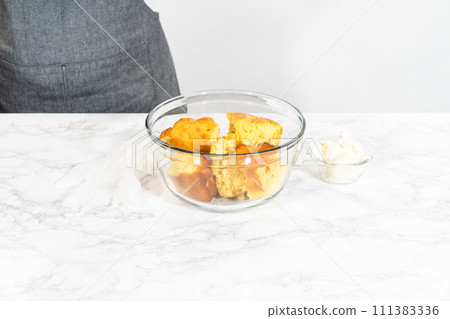 Mixing ingredients in a large glass mixing bowl to make cactus cake pops for the Cinco de Mayo celebration. 111383336