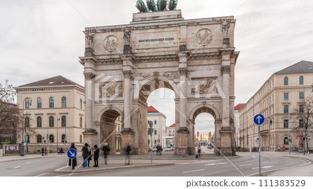 The Siegestor or Victory Gate in Munich is a memorial arch, crowned with a statue of Bavaria with a lion quadriga timelapse. Germany 111383529