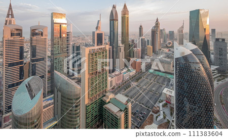 Skyline view of the high-rise buildings on Sheikh Zayed Road in Dubai aerial night to day timelapse, UAE. 111383604