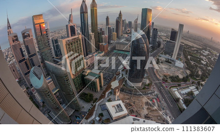 Skyline panorama of the high-rise buildings on Sheikh Zayed Road in Dubai aerial night to day timelapse, UAE. 111383607