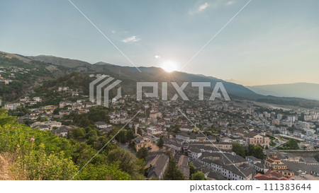 Panorama showing sunset over Gjirokastra city from the viewpoint of the fortress of the Ottoman castle of Gjirokaster timelapse. Panorama showing sunset over Gjirokastra city from the viewpoint of the fortress of the Ottoman castle of Gjirokaster timelapse. 111383644