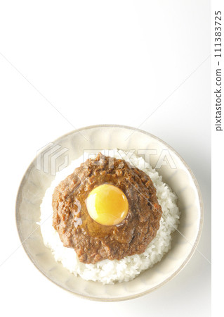 Overhead shot of piping hot keema curry topped with egg yolk against a white background 111383725