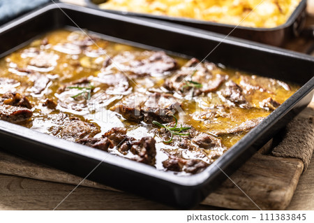 Juicy roasted pork neck with garlic and onion sauce 111383845