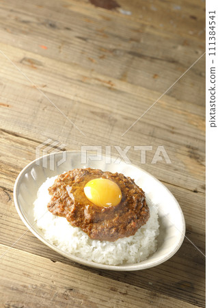 Spicy hot keema curry topped with egg yolk Spicy hot keema curry topped with egg yolk 111384541