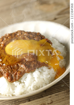 Spicy hot keema curry topped with egg yolk Spicy hot keema curry topped with egg yolk 111384568