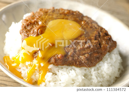 Spicy hot keema curry topped with egg yolk Spicy hot keema curry topped with egg yolk 111384572