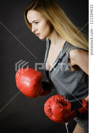 Woman wearing boxing gloves Woman wearing boxing gloves 111384632