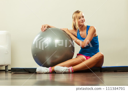 woman doing fitness exercises with fit ball woman doing fitness exercises with fit ball 111384701