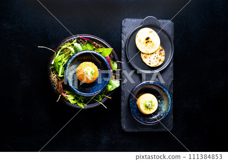 Closeup of some spanish croquettes in a bed of lettuce served as tapas 111384853
