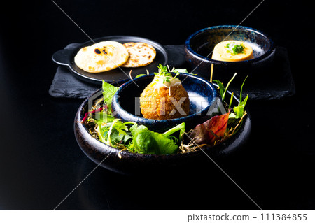 Closeup of some spanish croquettes in a bed of lettuce served as tapas 111384855