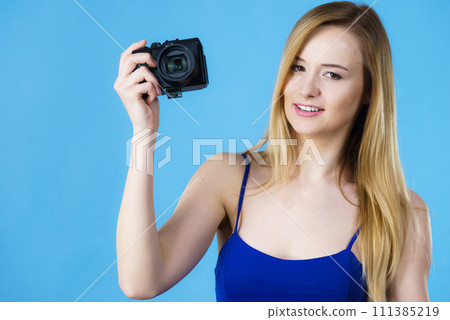 Young woman holding old fashioned camera 111385219
