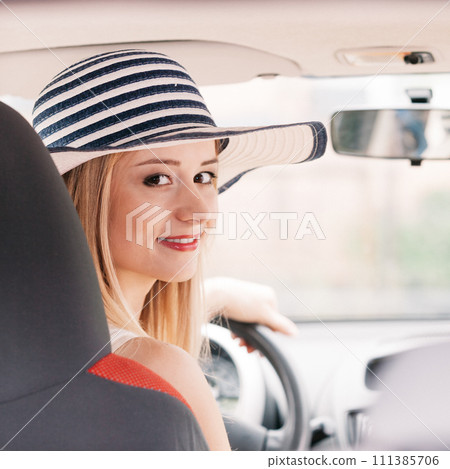 Pretty woman driving her car 111385706